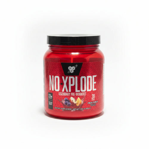 A red tub of NoXplore pre-workout supplement with a black lid, sitting on a white countertop in an indoor setting.