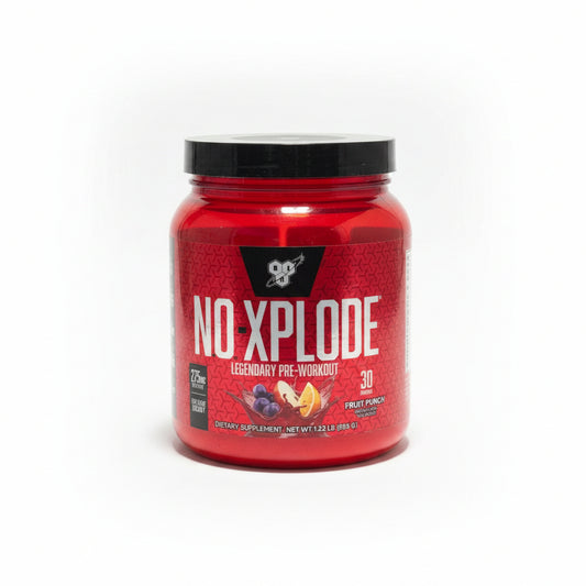 A red tub of NoXplore pre-workout supplement with a black lid, sitting on a white countertop in an indoor setting.